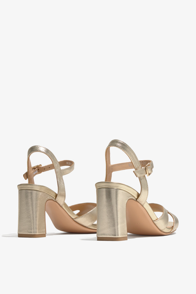 CHELLY-02 wingtip-heel sandal in platino leather with decorative heel