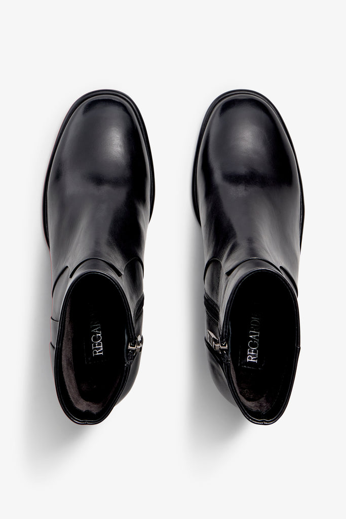 black leather ankle boot features a 65 mm heel, zipper, accentuated stitching, rubber sole, and plateau.
