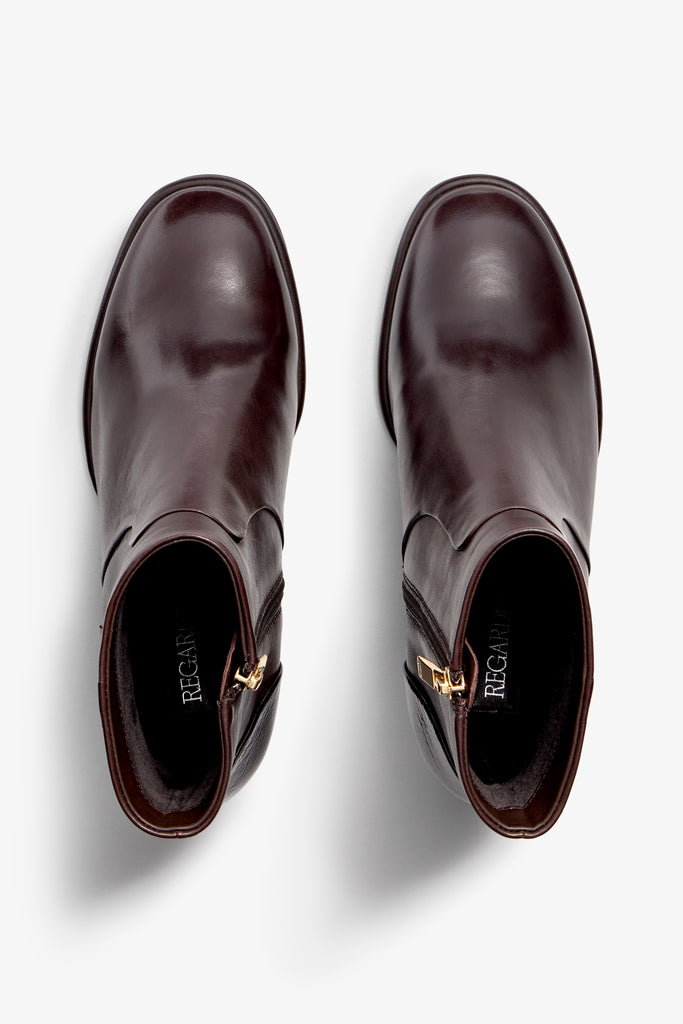 castagno dark brown leather ankle boot features a 65 mm heel, zipper, accentuated stitching, rubber sole, and plateau.