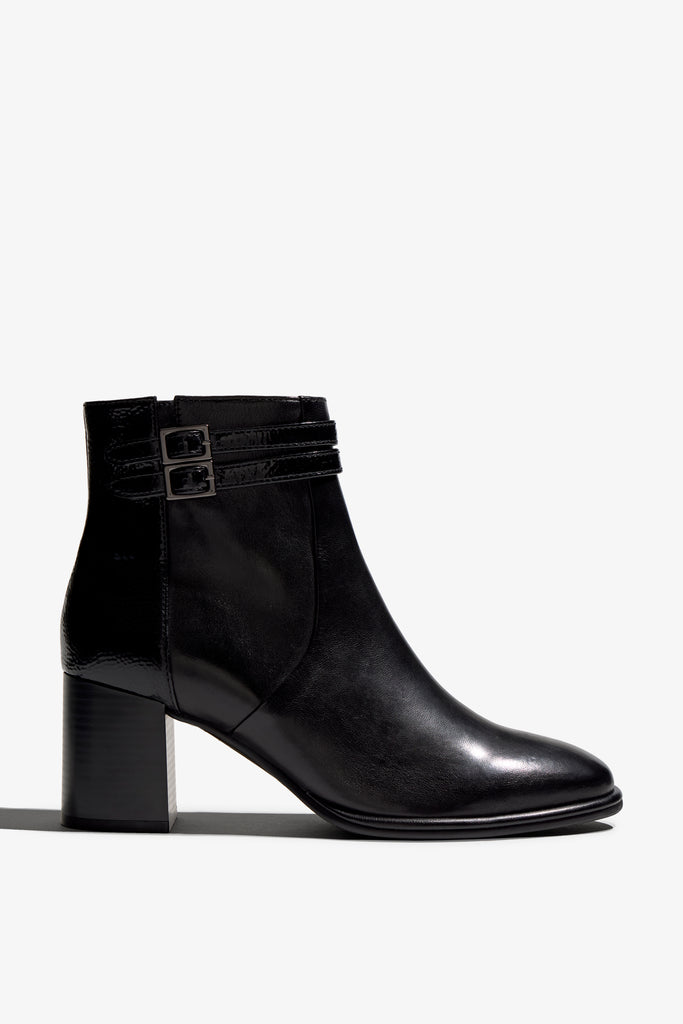 black leather ankle boot features a 65 mm heel, zipper, accentuated stitching, rubber sole, plateau and buckle straps.