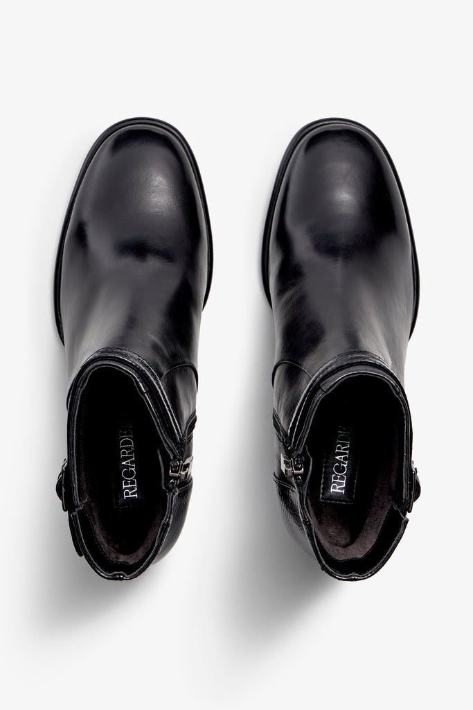 black leather ankle boot features a 65 mm heel, zipper, accentuated stitching, rubber sole, plateau and buckle straps.