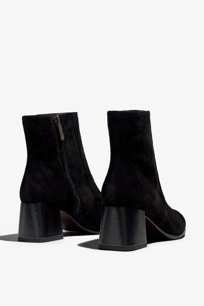 black suede ankle boot features 60mm heel, zipper, accentuated stitching, rubber sole, naplak block heel and memory foam footbed.