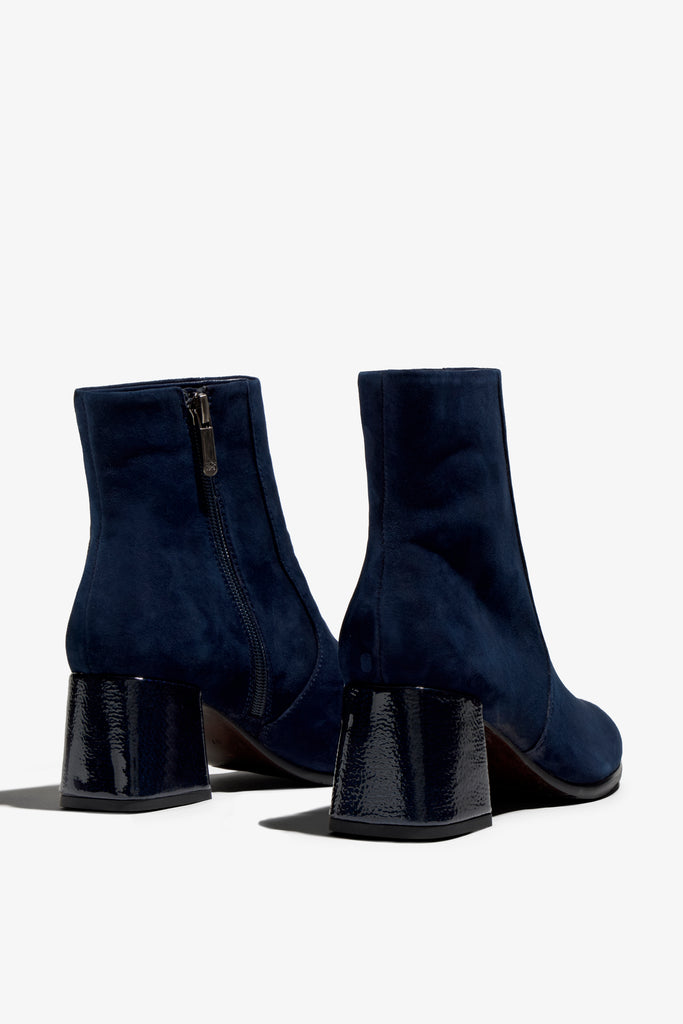 navy suede ankle boot features 60mm heel, zipper, accentuated stitching, rubber sole, naplak block heel and memory foam footbed.