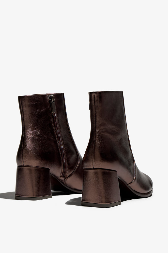 ebano metallic ankle boot features 60mm heel, zipper, accentuated stitching, rubber sole, block heel and memory foam footbed.
