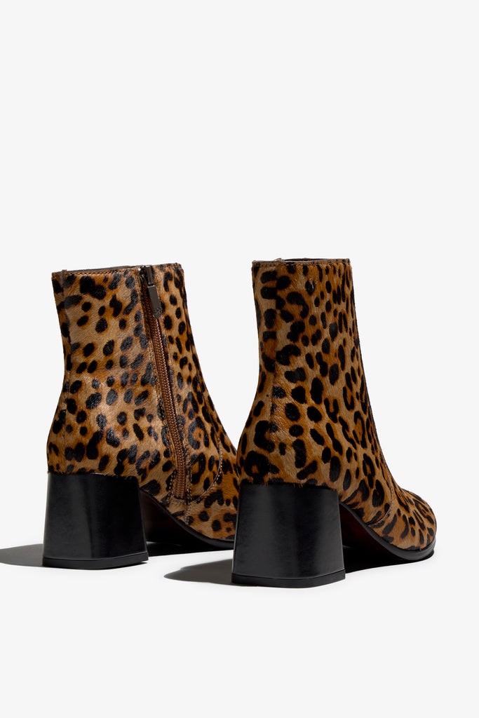leopard print ankle boot features 60mm heel, zipper, accentuated stitching, rubber sole, block heel and memory foam footbed.