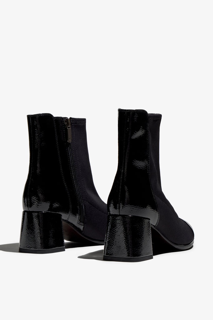 black leather stretch ankle boot features 60mm heel, zipper, accentuated stitching, rubber sole, block heel and memory foam footbed.