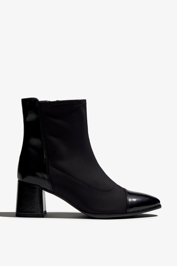 black leather stretch ankle boot features 60mm heel, zipper, accentuated stitching, rubber sole, block heel and memory foam footbed.