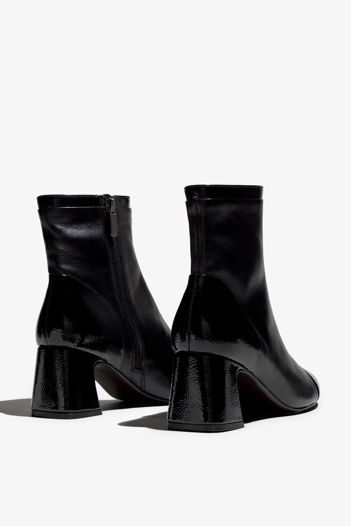 Black ankle boot, 60mm heel, zipper, accentuated stitching, rubber sole, and memory foam footbed.