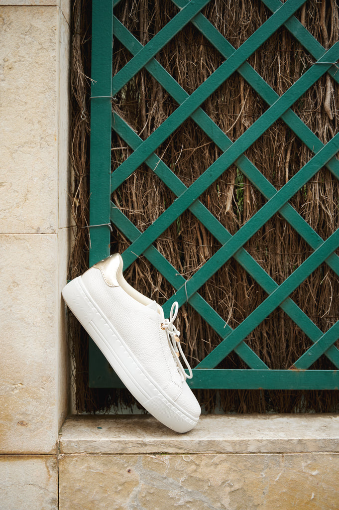 Nathaly-01 White Platino leather sneakers by Regarde Le Ciel with gold side accents and gold-detailed laces.