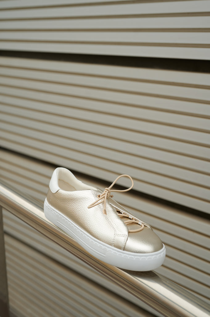 Nathaly-01 Platino leather sneakers by Regarde Le Ciel with gold side accents and gold-detailed laces.