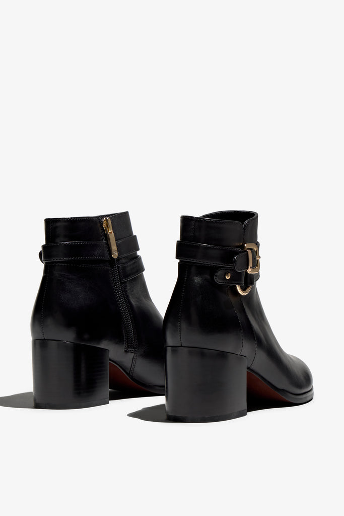 black leather ankle bootie, 60 mm, zipper, buckles and metal accessories, accentuated stitching, block heel, rubber sole.