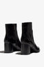 black leather ankle boot features a 65 mm heel, zipper, accentuated stitching, rubber sole, and plateau.