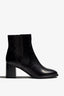 black leather ankle boot features a 65 mm heel, zipper, accentuated stitching, rubber sole, and plateau.