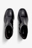 black leather ankle boot features a 65 mm heel, zipper, accentuated stitching, rubber sole, and plateau.
