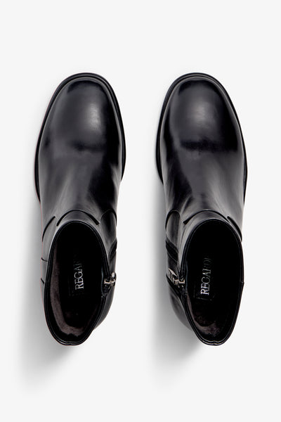 black leather ankle boot features a 65 mm heel, zipper, accentuated stitching, rubber sole, and plateau.