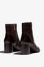 castagno dark brown leather ankle boot features a 65 mm heel, zipper, accentuated stitching, rubber sole, and plateau.