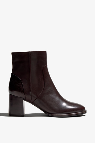 castagno dark brown leather ankle boot features a 65 mm heel, zipper, accentuated stitching, rubber sole, and plateau.