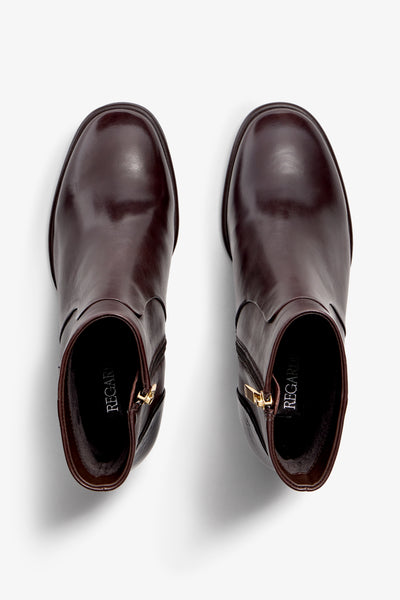 castagno dark brown leather ankle boot features a 65 mm heel, zipper, accentuated stitching, rubber sole, and plateau.