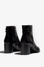 black leather ankle boot features a 65 mm heel, zipper, accentuated stitching, rubber sole, plateau and buckle straps.