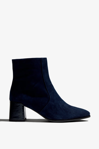 navy suede ankle boot features 60mm heel, zipper, accentuated stitching, rubber sole, naplak block heel and memory foam footbed.