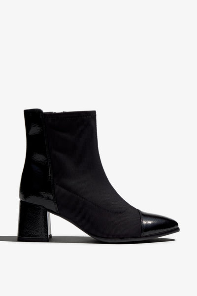 black leather stretch ankle boot features 60mm heel, zipper, accentuated stitching, rubber sole, block heel and memory foam footbed.