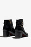 black leather ankle bootie, 60 mm, zipper, buckles and metal accessories, accentuated stitching, block heel, rubber sole.